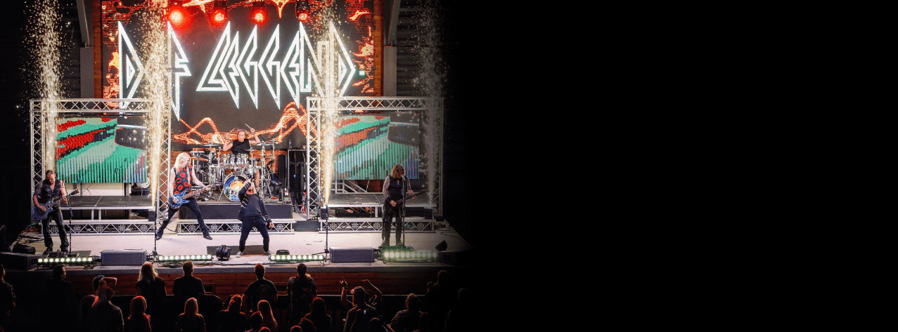 Def Leggend performing live under pyrotechnics and LED staging